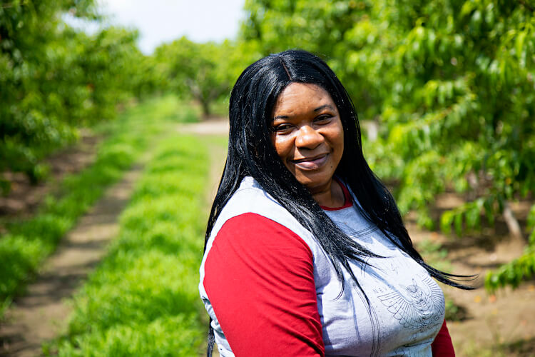Desrine, Seasonal Agricultural Worker from Jamaica, working on a fruit farm