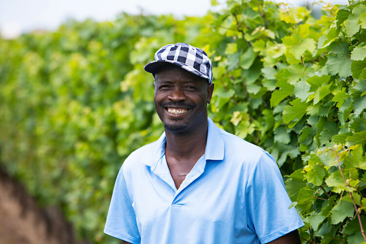 male migrant worker smiles for the camera