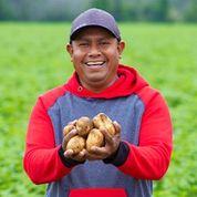male migrant worker smiling for the camera