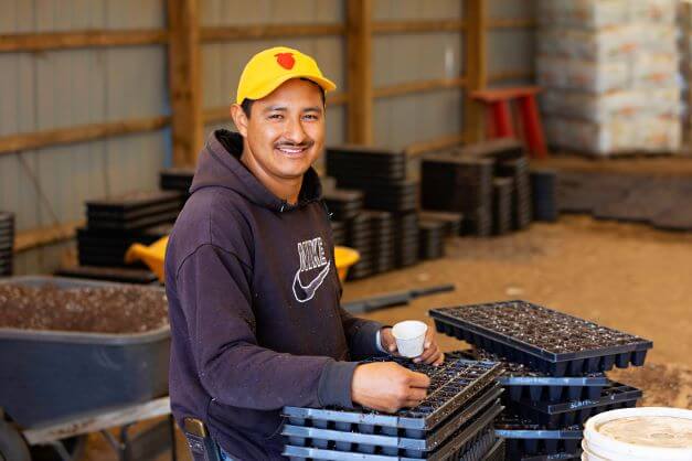 male migrant worker smiling for camera