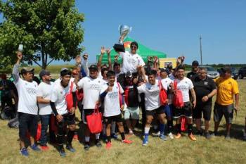 winning soccer team celebrates with trophy