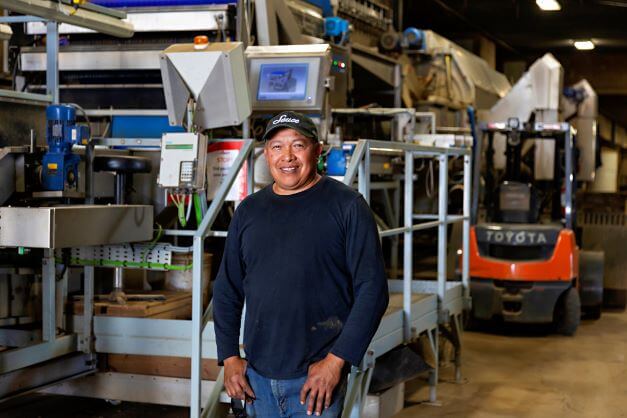 male farm worker standing in warehouse facility