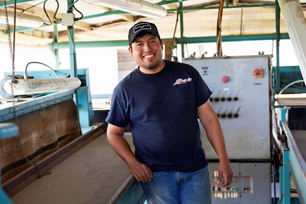 male farm worker smiling for camera