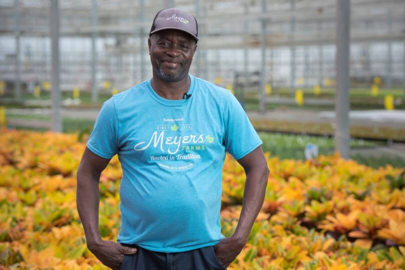 male farm employee posing for camera