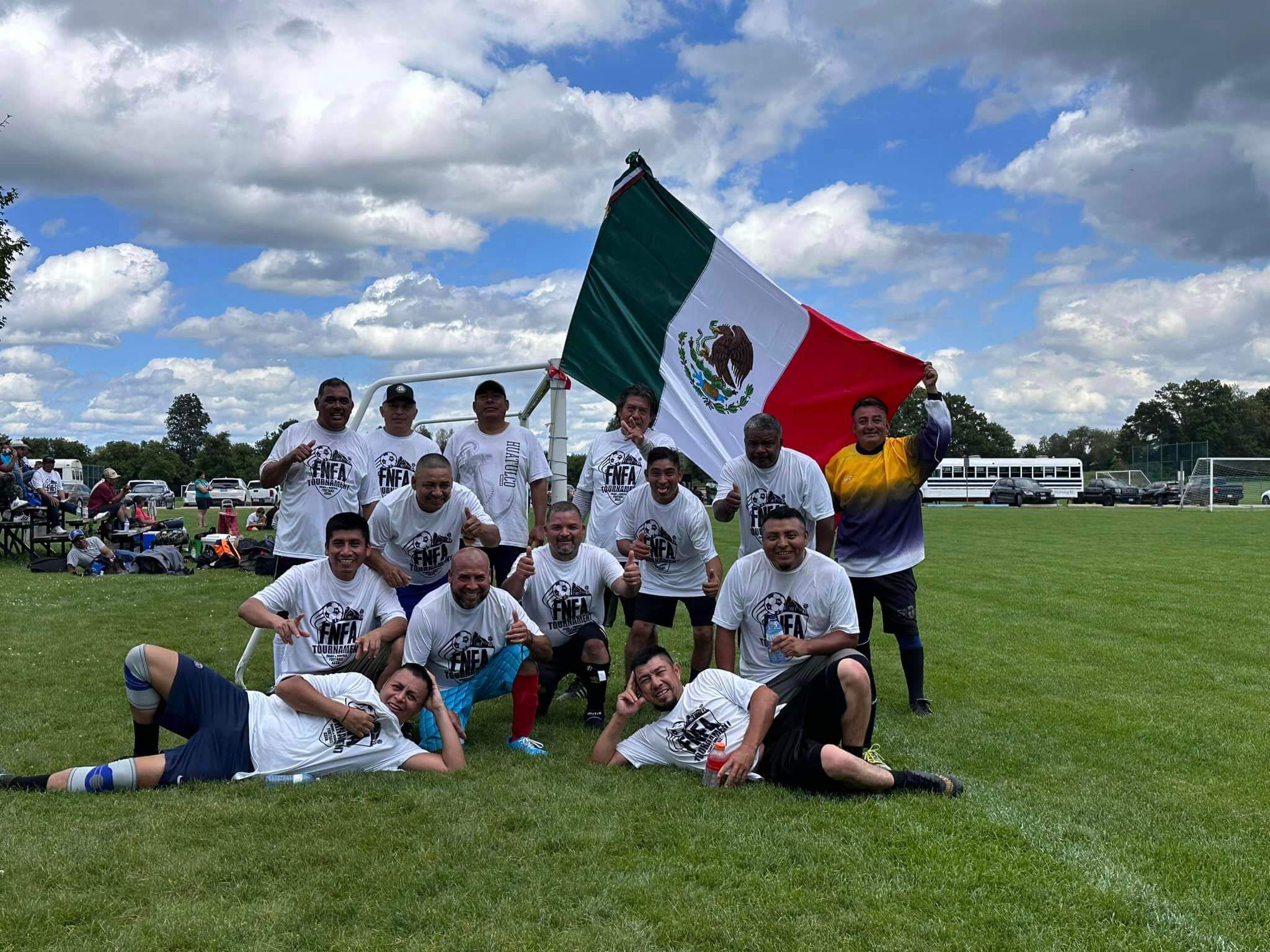 Soccer team holding Mexican flag
