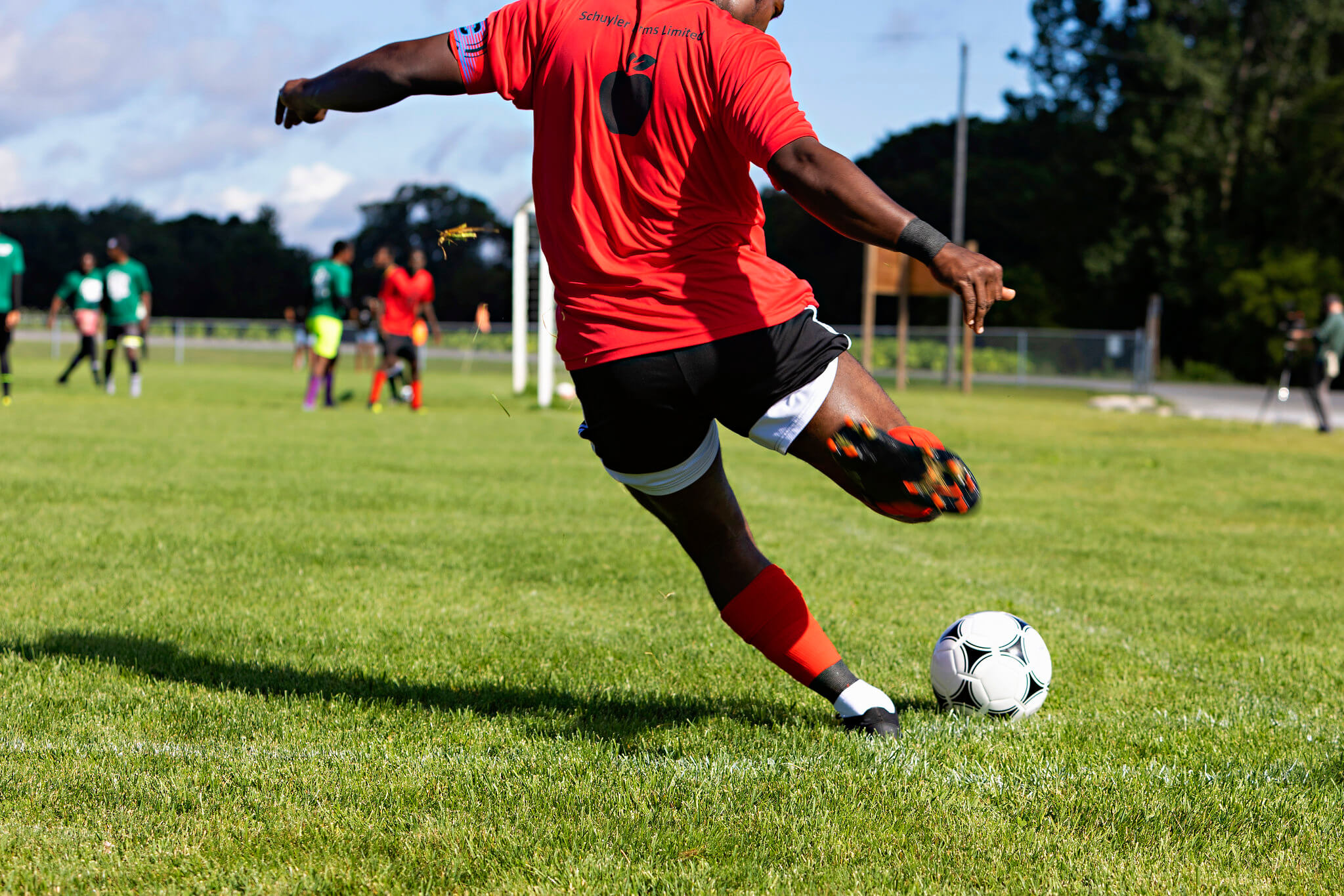 soccer player kicking ball