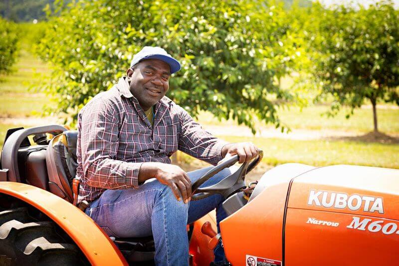 farm worker sits in tractor