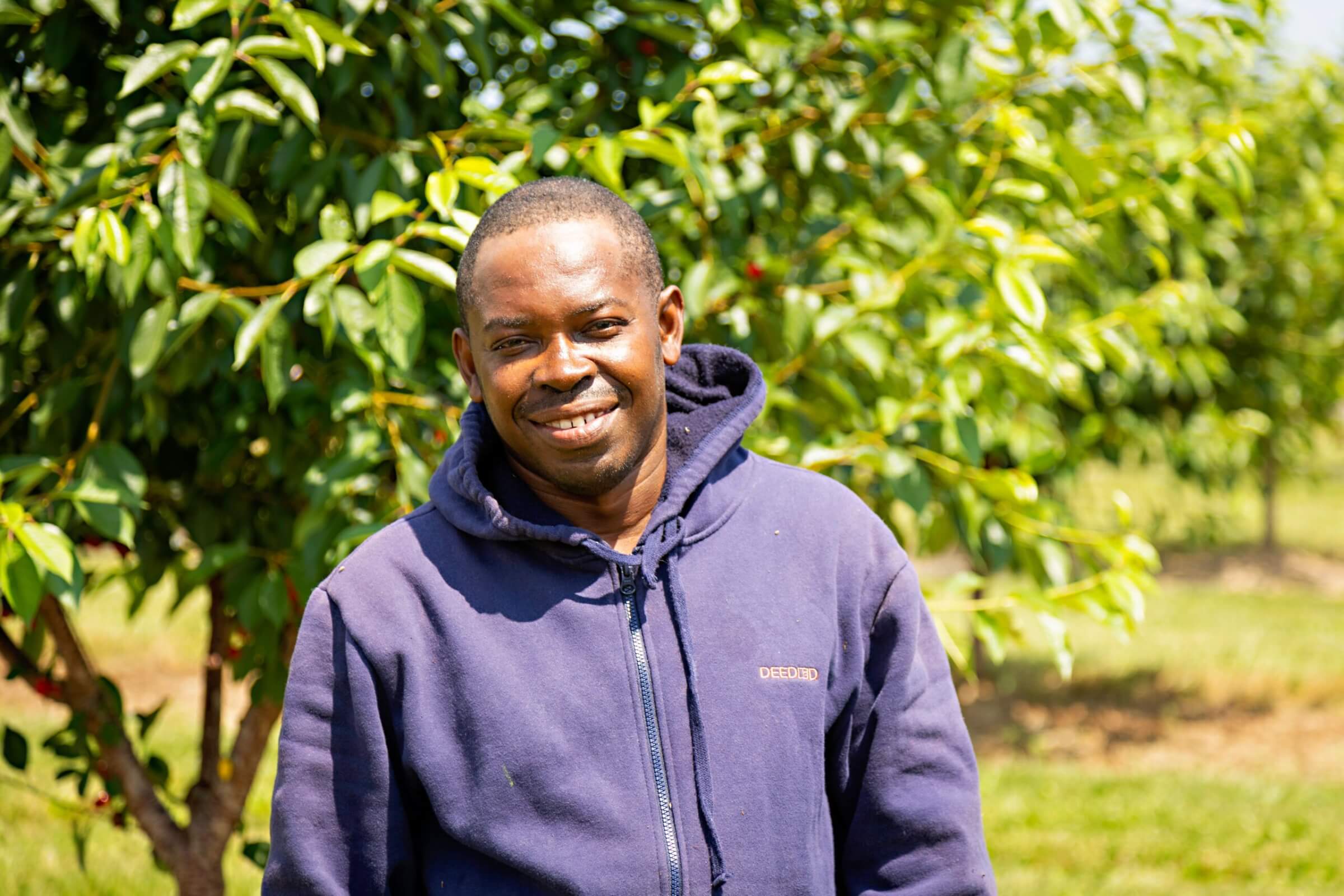 farm worker smiles for camera