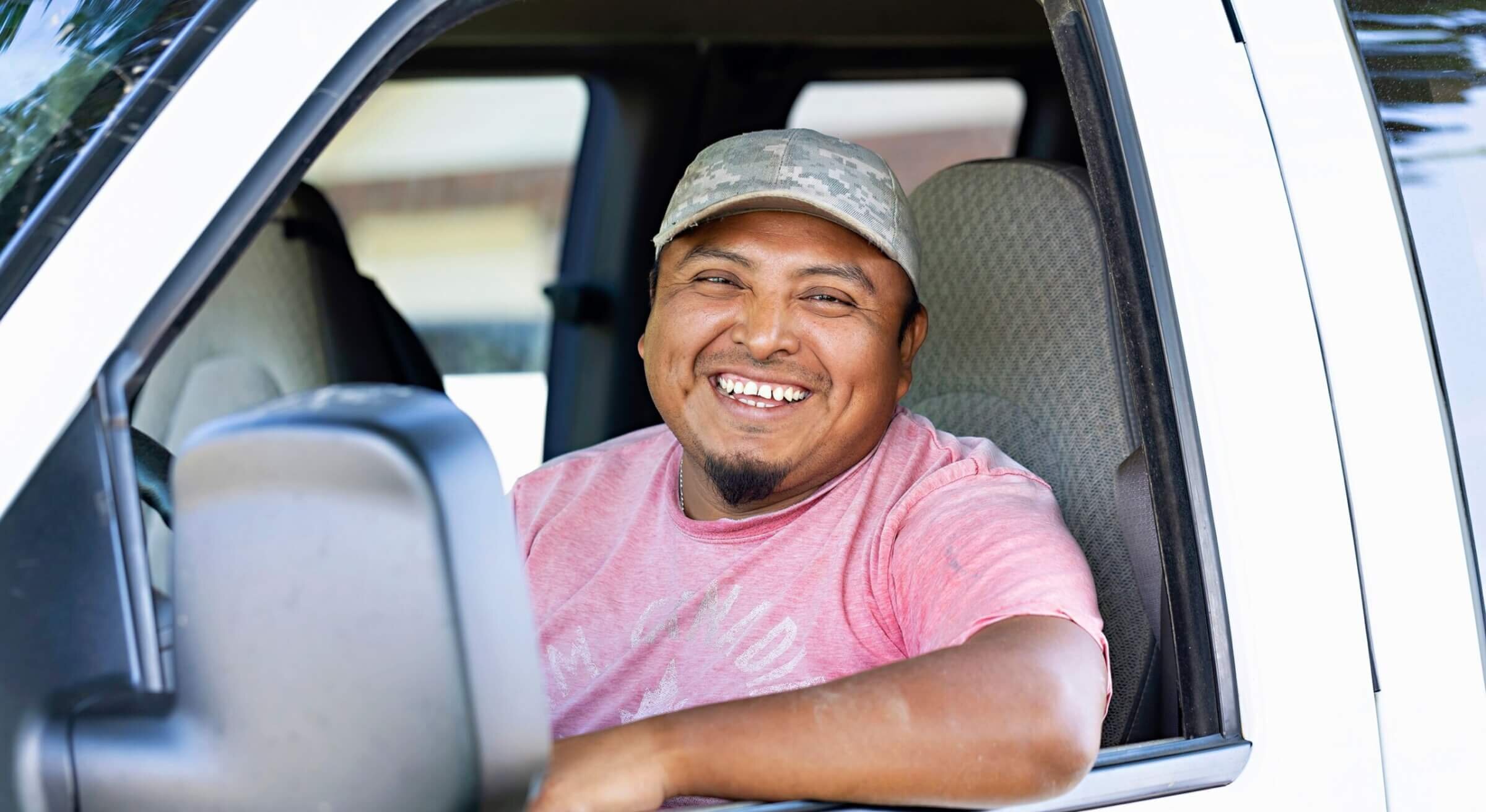 male farm employee poses for camera