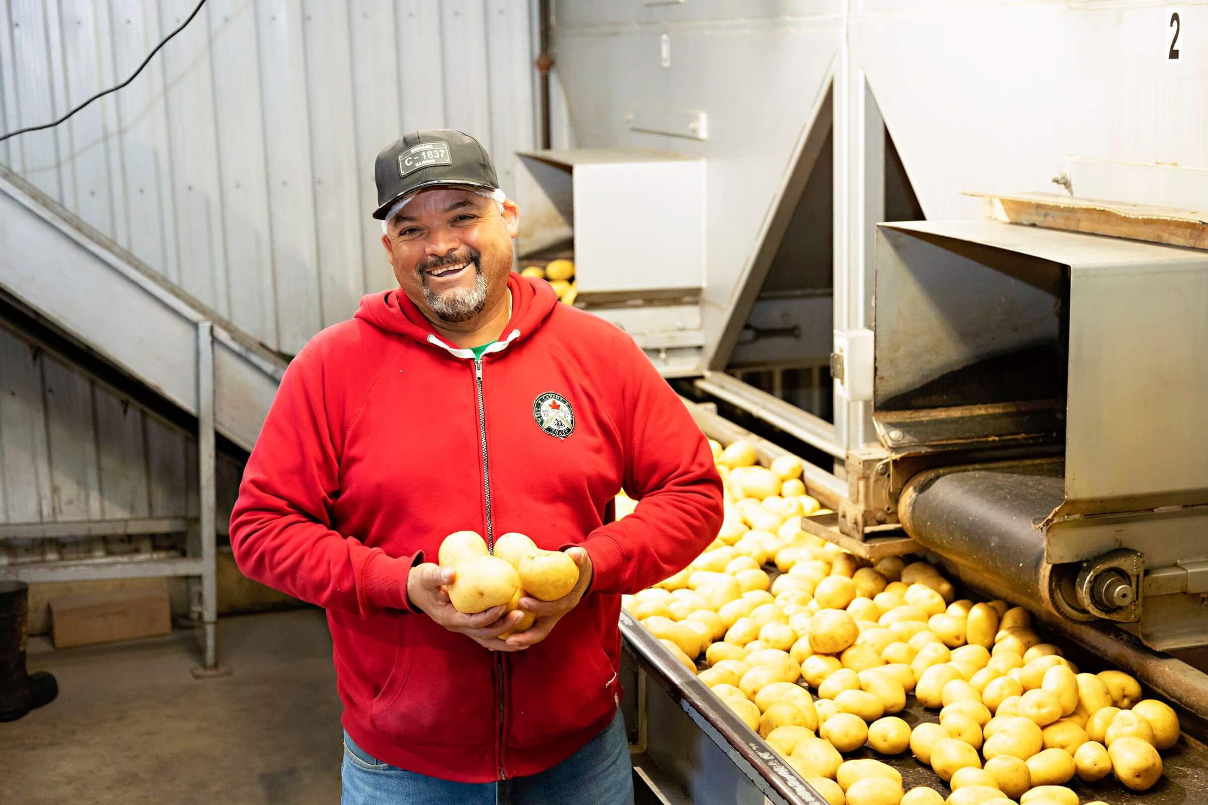 male farm employee smiles for camera