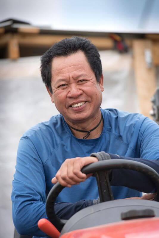 male farm worker driving machine